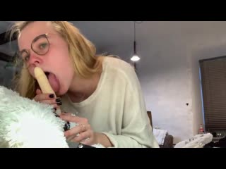 a young blonde bitch is having fun with a toy